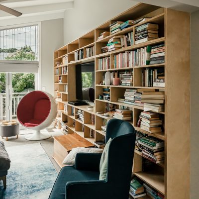 a room with a book shelf and a couch